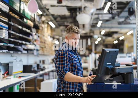 Man working in a printing factory Stock Photo