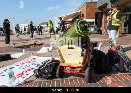 01 June 2024, Schleswig-Holstein, Westerland (sylt): A small group of punks hold a rally on the beach promenade in Westerland after the racism scandal on Sylt. They carry a banner with the slogan 'Human rights instead of right-wing people' and a sign with the slogan 'Prevent progroms of tomorrow'. Photo: Bodo Marks/dpa Stock Photo