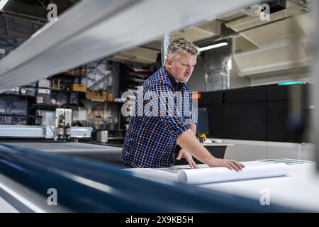 Man working in a printing factory Stock Photo