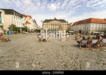 Farmers Market Square, known as Zelny Trh or Cabbage Market Square in Old Town Brno, Czech Republic with people relaxing in lawn chairs, sunny day. Stock Photo