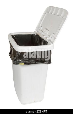 Vertical side shot of a dirty white tall kitchen trash can with black trash bag and lid open. Stock Photo