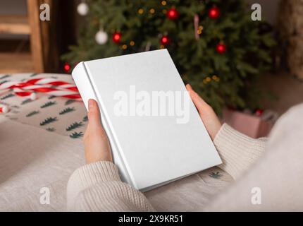 Woman writing christmas wish list. Mockup background with hand, new year gift view. Winter write on paper, clean cover. Noel checklist, table goals, f Stock Photo