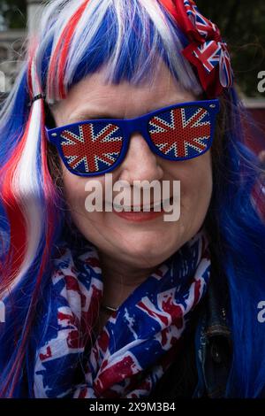 London, UK. 01st June, 2024. A woman with Union Jack sunglasses seen during the screening of Tommy Robinson's new documentary 'LAWFARE'. The public screening highlights a two-tier policing system that Tommy Robinson claims is happening nationally. Credit: SOPA Images Limited/Alamy Live News Stock Photo