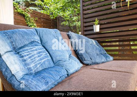 Garden terrace, resting place, garden furniture made of wooden pallets, pergola and flowers Stock Photo