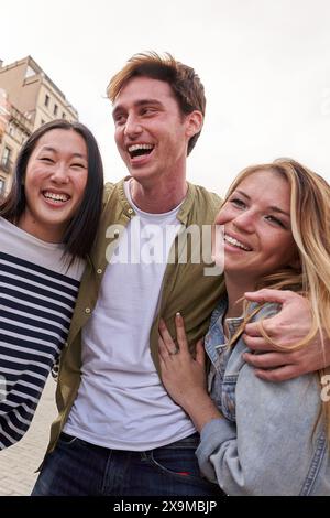 Multiracial young people hugging together outdoor, diverse students and friends laughing happy Stock Photo