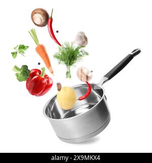 Fresh ingredients falling into saucepan on white background Stock Photo