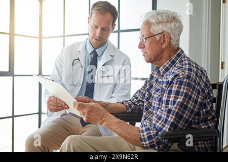Doctor, man and wheelchair with document for consultation, report or medical review in hospital. Medic, clipboard and person with disability in clinic Stock Photo