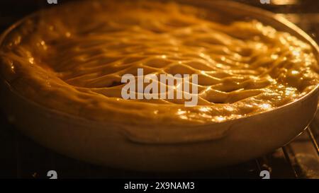 The process of baking a berry pie in the oven in a home kitchen Stock Photo