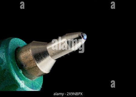 Focus stacked image of a ballpoint pen tip photographed at 4:1 magnification against black background. Stock Photo