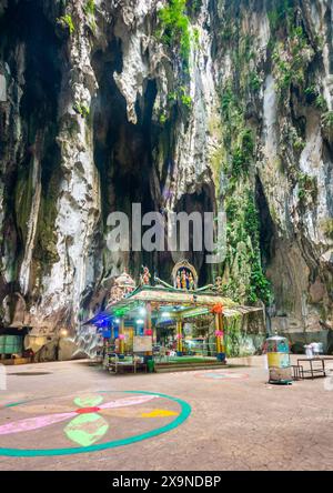 Hindu religious structures,,constructed in 1920, adorn the interior spaces of the vast sacred limestone cave,with an opening to the sky above at one e Stock Photo