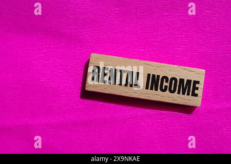 Rental income words written on ripped blue paper with yellow background ...