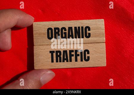 Organic traffic words written on wooden blocks with red background. Conceptual organic traffic symbol. Copy space. Stock Photo
