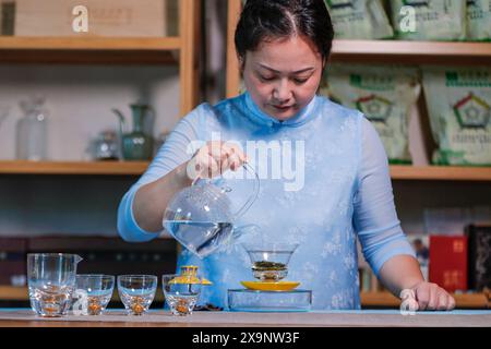 (240602) -- HUANGSHAN, June 2, 2024 (Xinhua) -- Wang Sun makes tea at Demingshe, a tea art vocational training school in Huangshan City, east China's Anhui Province, May 23, 2024. Wang Sun is the founder of Demingshe, a tea art vocational training school in Huangshan City. Huangshan City is the place of origin of several famous teas including Huangshan Maofeng, Taiping Houkui and Keemun black tea, and boasts a long history of drinking tea. As a pioneer in developing innovative tea-making skills and alternative ways of drinking tea, Wang started the research and promotion of the new-style Stock Photo