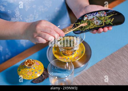 (240602) -- HUANGSHAN, June 2, 2024 (Xinhua) -- Wang Sun makes tea at Demingshe, a tea art vocational training school in Huangshan City, east China's Anhui Province, May 23, 2024. Wang Sun is the founder of Demingshe, a tea art vocational training school in Huangshan City. Huangshan City is the place of origin of several famous teas including Huangshan Maofeng, Taiping Houkui and Keemun black tea, and boasts a long history of drinking tea. As a pioneer in developing innovative tea-making skills and alternative ways of drinking tea, Wang started the research and promotion of the new-style Stock Photo