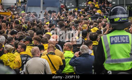 London, UK. 01st June, 2024. The 'Ultras', BVB hardcore fans arrive under police escort. Fans of both clubs arrive and make their way along Olympic Way to the stadium. The UEFA Champions League Final between Real Madrid and Borussia Dortmund will kick off at 8pm GMT at Wembley Stadium today. Credit: Imageplotter/Alamy Live News Stock Photo