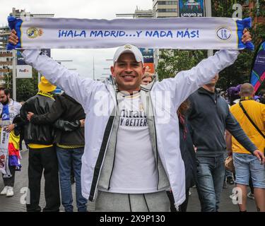 London, UK. 01st June, 2024. A Real Madrid fan with scarf. Borussia Dortmund fans pose and sing in club kit with flags and scarves. Fans of both clubs arrive and make their way along Olympic Way to the stadium. The UEFA Champions League Final between Real Madrid and Borussia Dortmund will kick off at 8pm GMT at Wembley Stadium today. Credit: Imageplotter/Alamy Live News Stock Photo