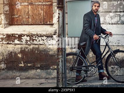 Bike, city and man portrait with morning commute to job on urban sidewalk with carbon neutral transport. Bicycle, sustainable and eco travel on road Stock Photo