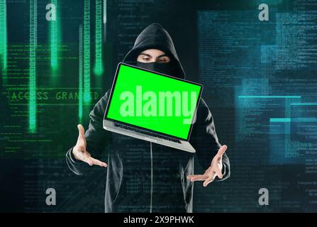 Man, laptop and portrait on black background for hacking, phishing and malware with green screen. Hacker, software and floating tech for cyber crime Stock Photo