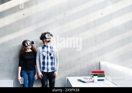 Young university students with VR headset. Virutal reality in academic settings. VR technology. Stock Photo
