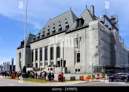 Ottawa, Canada - June 1, 2024: A group of people line up to see inside the Supreme Court building as part of the annual Doors Open event which allows people to see inside and learn about various buildings in the area. Stock Photo