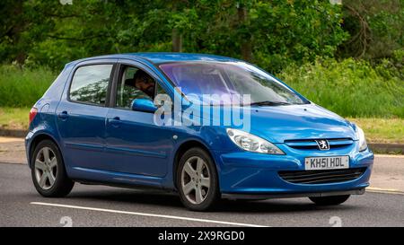 Milton Keynes,UK - May 27th 2024: 2002 blue Peugeot 307 car driving on a British road Stock Photo