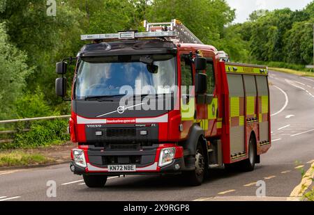 Milton Keynes,UK - May 27th 2024:  Buckinghamshire Fire and Rescue Service fire engine driving on a British road car driving on a British road Stock Photo