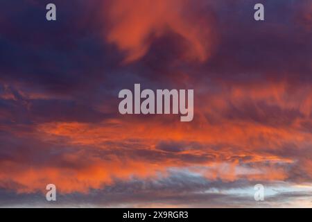 Dramatic fiery sunset, sky with fire of red and orange clouds, open air cloudscape Stock Photo