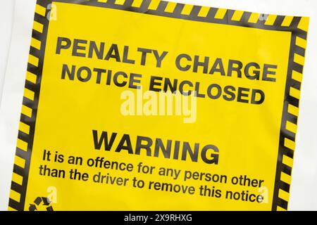 parking fine - yellow penalty charge notice - UK Stock Photo