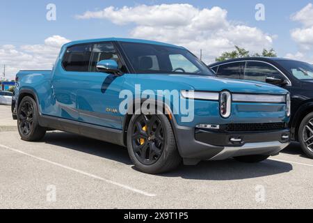 Indianapolis - May 30, 2024: Rivian R1T EV pickup truck display. Rivian offers the R1T in Adventure, Adventure All-Terrain and Launch editions. MY:202 Stock Photo