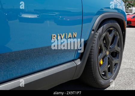 Indianapolis - May 30, 2024: Rivian R1T EV pickup truck display. Rivian offers the R1T in Adventure, Adventure All-Terrain and Launch editions. MY:202 Stock Photo