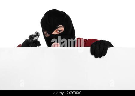 Thief in balaclava with gun on white background Stock Photo