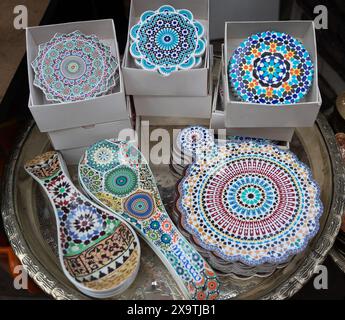 Jemaa el-Fnaa, Marrakech, Morocco - March 18, 2024: Vibrant display of handmade Moroccan ceramic plates of traditional designs. Stock Photo