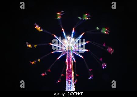 Spinning sky swing ride light trails at the Los Angeles County Fair- 23 May 2024 - Los Angeles, California - United States Stock Photo