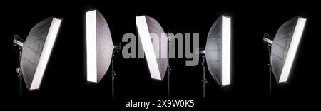 Photography studio flash on a lighting stand isolated on black background with copy space. Professional equipment like monobloc Stock Photo