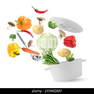 Fresh ingredients falling into saucepan on white background Stock Photo