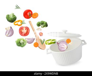 Fresh ingredients falling into saucepan on white background Stock Photo