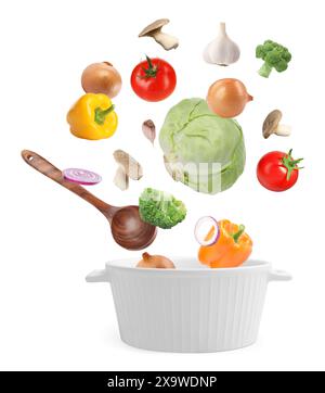 Fresh ingredients falling into saucepan on white background Stock Photo