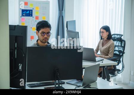 asian woman  and Indian man Developer team working  about programming software data online at office Stock Photo