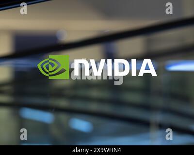 Nvidia logo on a window in a lobby. Stock Photo