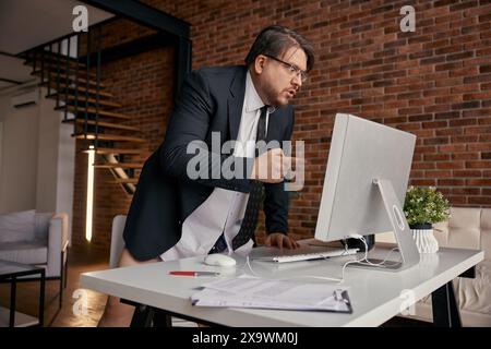 Mad businessman screaming on computer having online meeting at home office Stock Photo