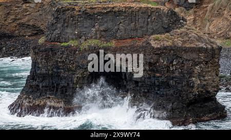 Roque Chico sea arch, an excellent example of coastal erosion by wave action from Rambla de Castro walking path near Puerto de la Cruz, Tenerife Stock Photo