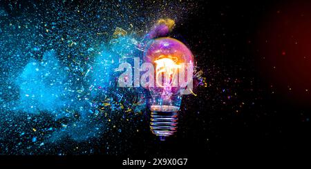Light bulb exploding with colorful powder on a black background Stock Photo