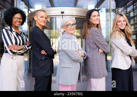 Side view business women led by the boss posing smiling for the camera. Stock Photo