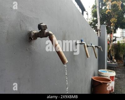 Water taps that are still on must be turned off Stock Photo