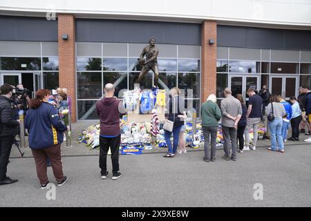 Members of the public pay tribute and view flowers and messages left at Headingley Stadium in Leeds, following the death of former Leeds Rhino player Rob Burrow who had Motor Neurone Disease. Picture date: Monday June 3, 2024. Stock Photo