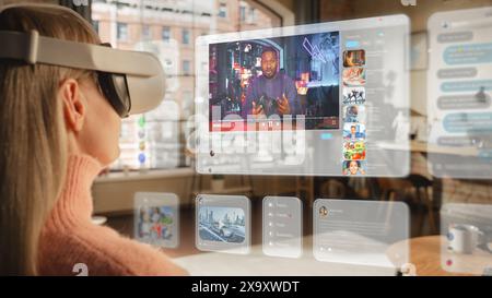 Metaverse Futuristic Concept: Woman Using Virtual Reality Headset to Watch Videos and Check Social Media. Over the Shoulder Footage of a Female Blogger Checking Tutorial Video to Improve her Content Stock Photo