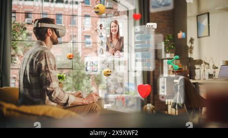 Portrait of a Handsome Man Using VR to Connect to Friends While Sitting in Stylish Cozy Loft Living Room. Man Getting Online Using Metaverse Software to Chat and Meet People Stock Photo