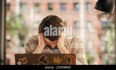 Concerned Manager Working Remotely from Home, Writing a Complicated Business Strategy, Trying to Make It Till Deadline. Serious Concentrated Specialist Using Laptop Computer in Living Room. Stock Photo