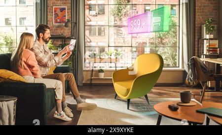 Metaverse Futuristic Concept: Young Man and Woman Using Augmented Reality to Buy a Fancy Chair Online. A Newly Married Couple Choosing Furniture for Their New Stylish Apartment Using High Technology Stock Photo