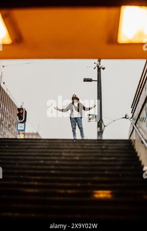 A guy is standing in the rain in front of the underpass at Budapest Hungary Stock Photo